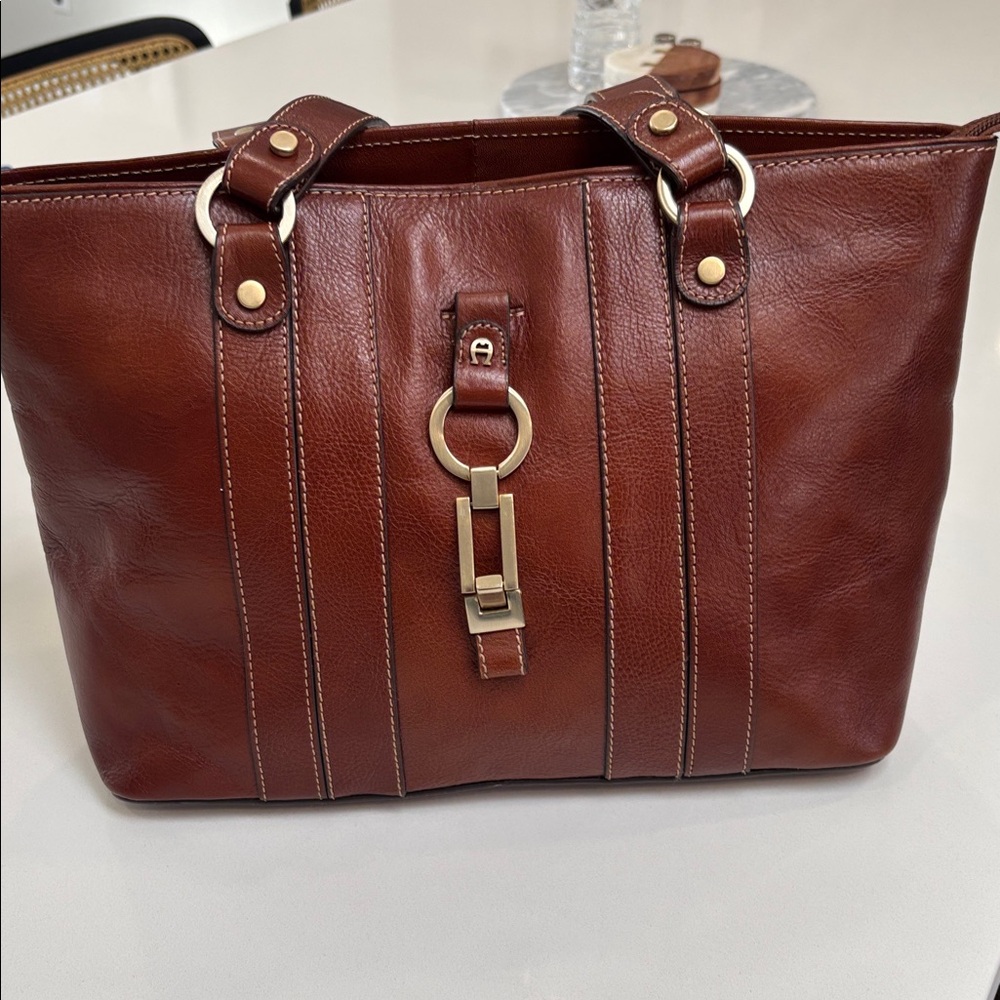 vintage Etienne Aigner brown leather tote bag with gold-tone hardware.